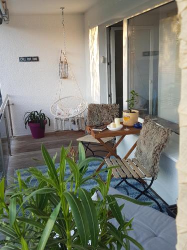 a patio with two chairs and a table on a porch at BoBi - 2 Schlafzimmer, Balkon, W-Lan, Parkplatz in Dortmund