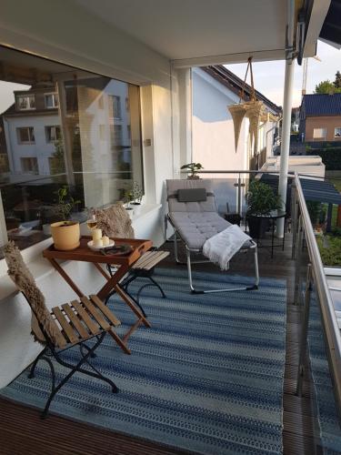 a balcony with a table and a bench on a patio at BoBi - 2 Schlafzimmer, Balkon, W-Lan, Parkplatz in Dortmund