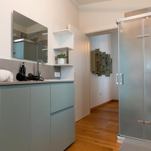 a white kitchen with a sink and a shower at Antica Corte Lugo in Lugo