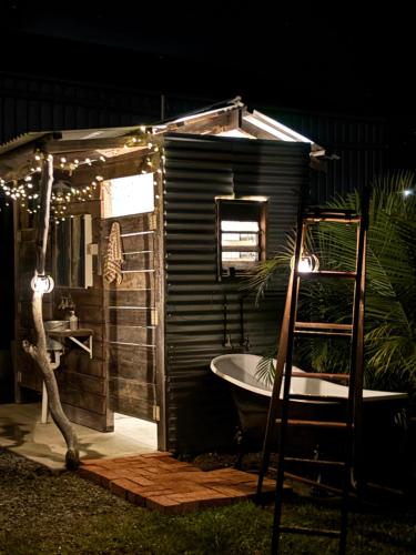 a small bathroom with a bath tub and a ladder at The Shed at Beechwood in Beechwood