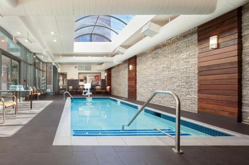a swimming pool in a hotel with a skylight at Courtyard by Marriott Boston Brookline in Brookline