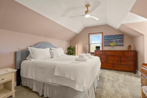 a bedroom with a bed and a dresser and a window at Harvest Haven- Cozy Downtown Winnebago Retreat in Rockford