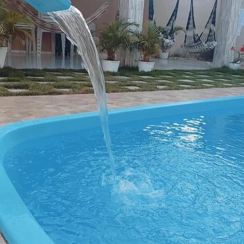 a water fountain in a swimming pool at Francisco das Chagas Andrade in Martins
