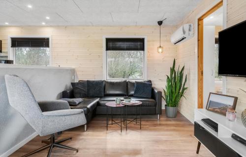 a living room with a couch and a table at Three-Bedroom Holiday Home In Vestervig in Vestervig