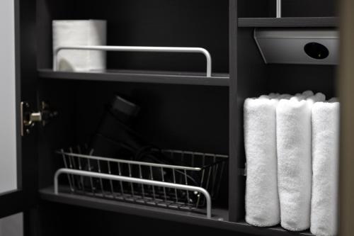 a refrigerator with white towels on a shelf at Odays Osiria Residence in Busan