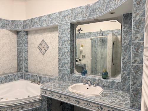 a bathroom with a tub and a sink at Salve Teplice in Teplice