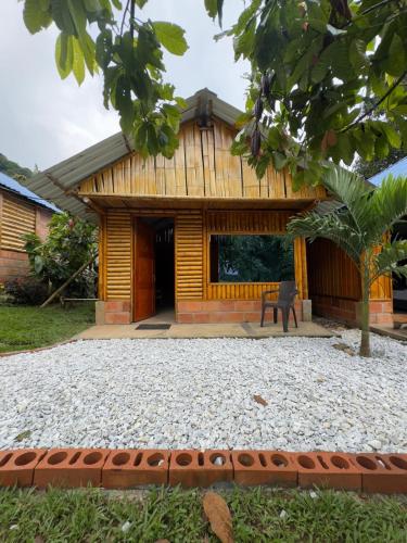 a house with a gravel yard in front of it at Cabañas orquídea in Norcasia