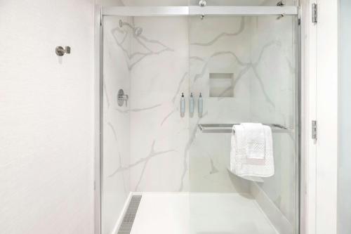 a white bathroom with a shower with a glass door at Courtyard Palo Alto Los Altos in Palo Alto