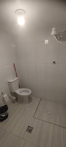 a bathroom with a toilet in a room at Casa Azul em Santa Tereza in Belo Horizonte