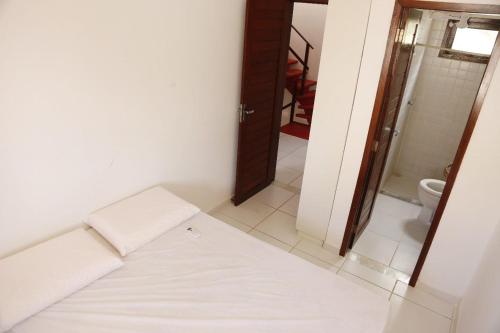 a small room with a bed and a bathroom at Tamandaré Residence Beach 2 in Tamandaré