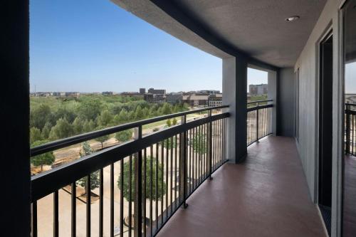 a balcony with a view of a forest at Courtyard by Marriott Dallas DFW Airport North/Grapevine in Grapevine