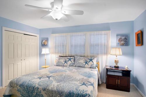 ein Schlafzimmer mit einem Bett und einem Deckenventilator in der Unterkunft Ginger's Guesthouse in Jekyll Island