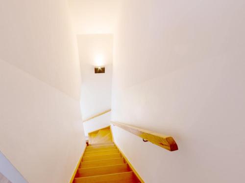 a hallway with a white wall with a light on it at Apartment in Brittany near Pentrez Beach in Saint-Nic