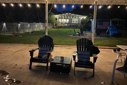 two chairs and a table on a patio at night at Dockside Digs in Kingsland