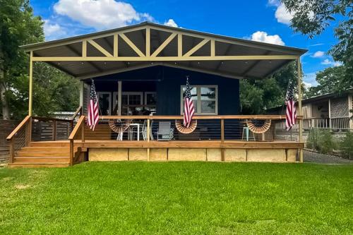 a house with a deck with american flags on it at Dockside Digs in Kingsland