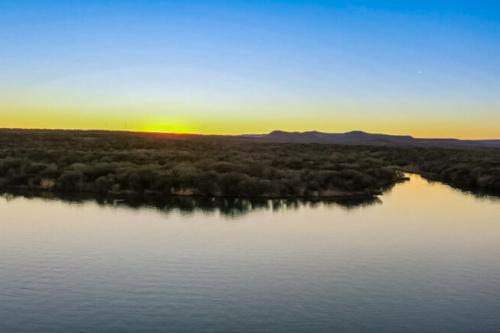 a view of a river with the sunset in the background at Dockside Digs in Kingsland