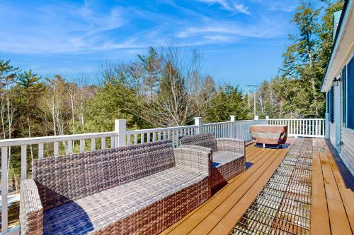 a porch with two benches on a wooden deck at Kindred Hollow in Ludlow