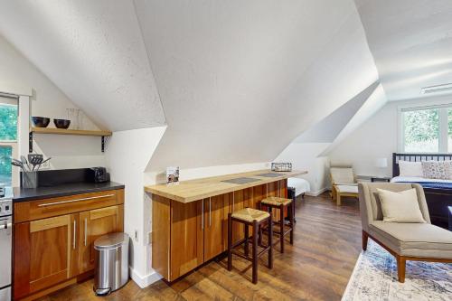 a kitchen with a counter and chairs in a room at Horsefeathers Farm Studio in Tolo