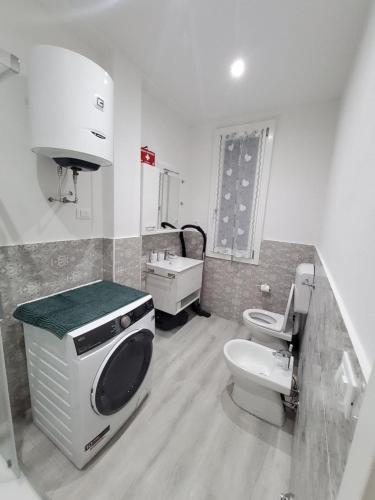 a bathroom with a toilet and a sink at Muzien B&B in Imola