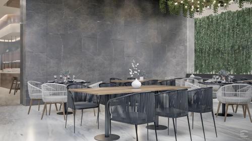 a restaurant with a wooden table and chairs at Holiday Inn Navojoa by IHG in Navojoa