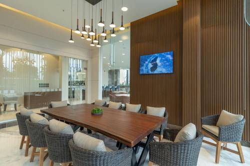 a dining room with a wooden table and chairs at Holiday Inn Navojoa by IHG in Navojoa