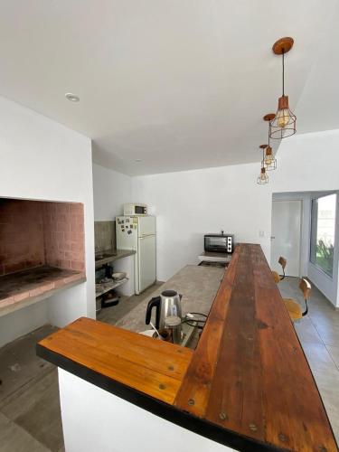 a kitchen with a wooden table in a room at Jencquel Home in Coronel Suárez