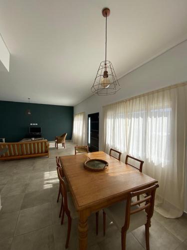 a dining room with a wooden table and chairs at Jencquel Home in Coronel Suárez