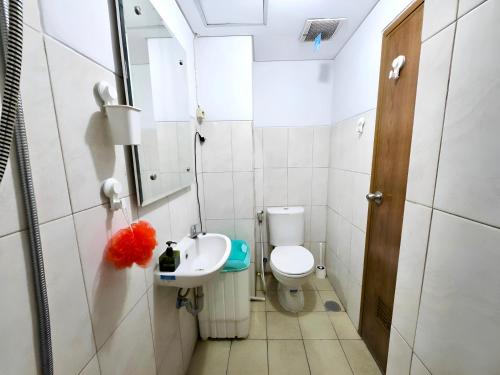 a small bathroom with a toilet and a sink at Apartemen amazana cozy, wifi, gym, pool in Cileduk 1