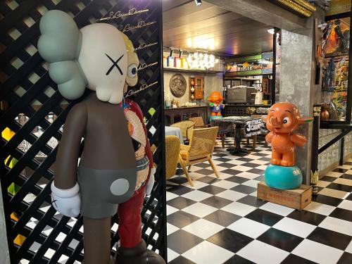 a room with a statue of a person with balloons at Years 1981 in Bangkok