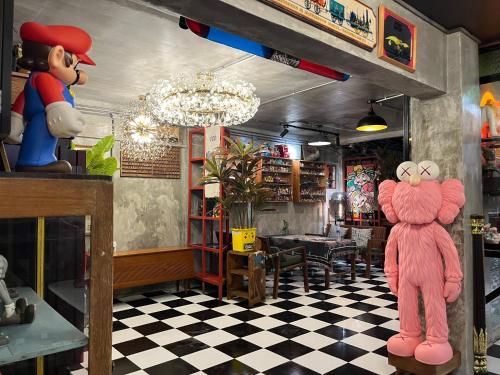 a restaurant with a pink mascot in a room at Years 1981 in Bangkok