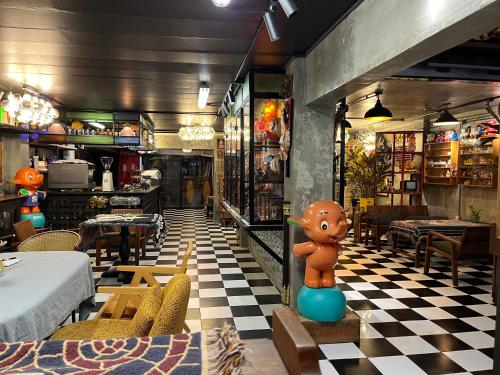 a restaurant with a teddy bear sitting on a table at Years 1981 in Bangkok