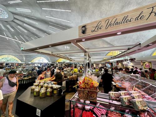 a group of people standing in a grocery store at Renovated villa with terrace, 750m to beach in Saint-Georges-de-Didonne
