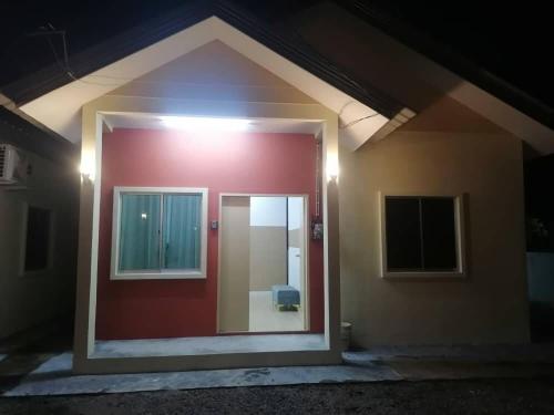 a red door of a house with a window at Comfy house in Melaka City Centre in Malacca