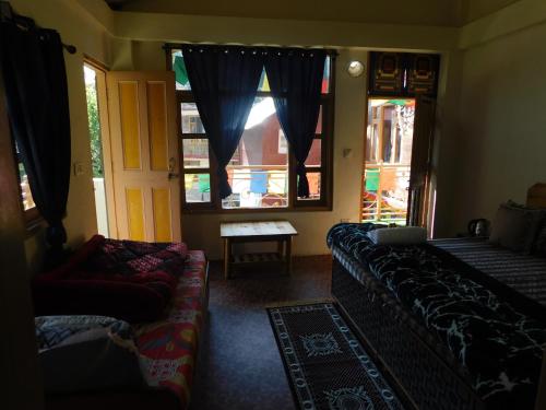 a living room with a couch and a window at The Sigiriya Old manali in Manāli