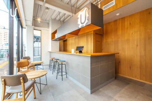 a bar in a restaurant with chairs and tables at Hotel Residence Asakusa by unito in Tokyo