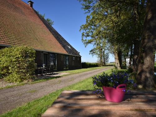 a pink flower pot sitting next to a house at Apartment in Workum near IJsselmeer Beach in Workum