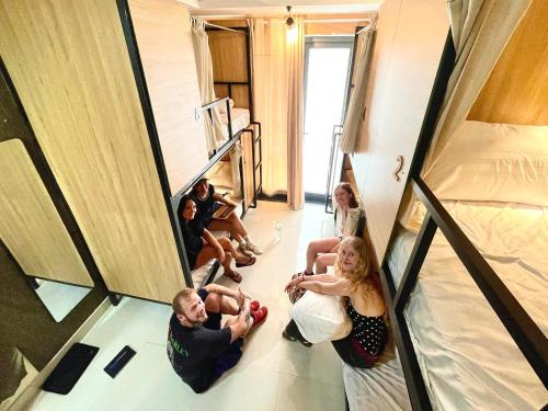 a group of people are sitting in a mirror at Hoi An Ancient Town Hostel & Bar in Hoi An