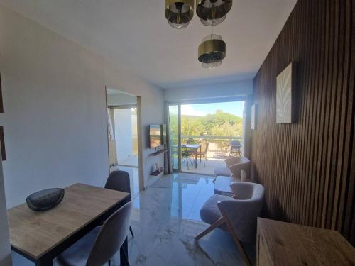 un salon avec une table et des chaises de salle à manger dans l'établissement Charmant appartement à Cavalaire-sur-Mer avec terrasse - FR-1-100-354, à Cavalaire-sur-Mer