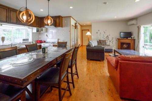 a kitchen and living room with a table and a couch at LuLu Manza in Onna