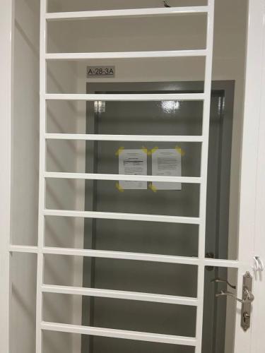 a white shelving unit in a room at Tulip Residence Elmina in Shah Alam