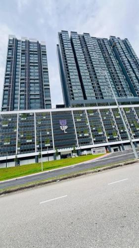 two tall buildings with a road in front of them at Tulip Residence Elmina in Shah Alam