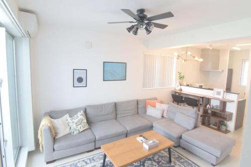 a living room with a couch and a table at Casa YONNA Miyakojima in Miyako-jima