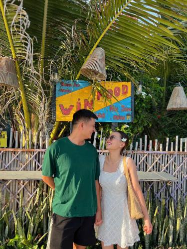 a man and a woman standing next to each other at Lê Huỳnh Guest House Family in Ke Ga