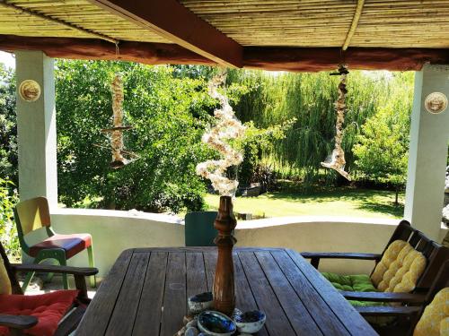 a wooden table on a porch with smoke coming at Karstaway Haven in Takaka