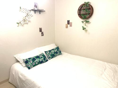 a bedroom with a bed with a green pillow on it at STAY MOMENT #Suwon in Suwon