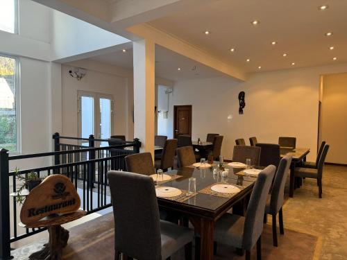 a dining room with a table and chairs at Winsanda Bungalow, Nuwara Eliya in Nuwara Eliya