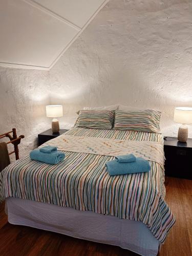 a bedroom with a bed with two towels on it at Cottage Bliss on Moonta Main St in Moonta