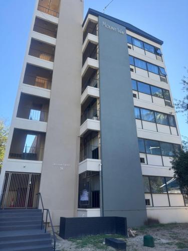 a building with a sign on the side of it at Mountway Holiday Apartments in Perth