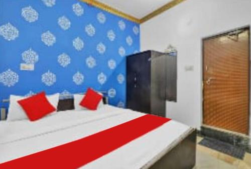 a bedroom with a large bed with red pillows at PREMIUM THE BEST HOTEL Near Railway Station - Wifi and Fully Air Conditioning Room - Prime Location - Room Service and Excellent Customer Service Awarded in Bādshāhnagar