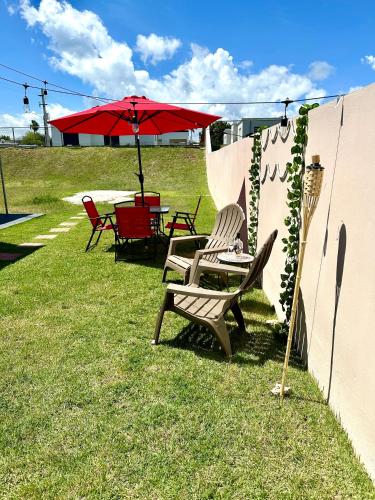 a couple of chairs and a table with an umbrella at La Casandra Beach House in Isabela